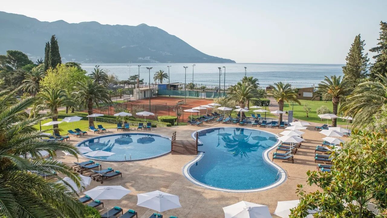 Resort swimming pools overlooking the Adriatic and mountains at a Bečići beachfront hotel