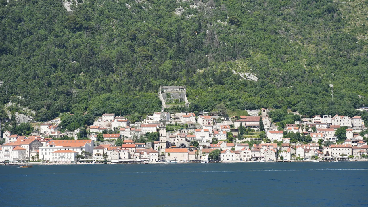 The islet church of Our Lady of the Rocks and its lighthouse in the Bay of Kotor near Perast