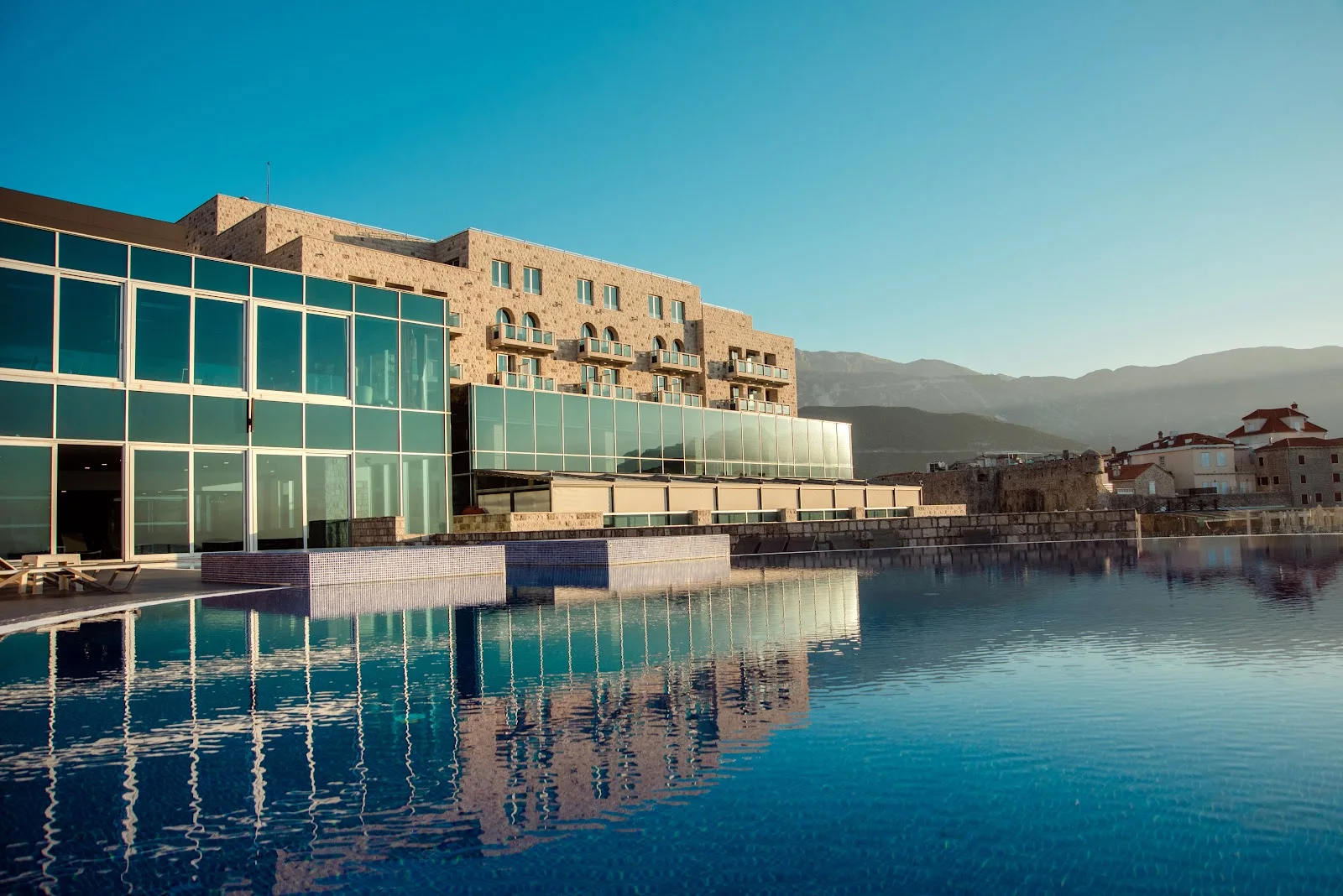 Infinity pool overlooking Budva's old town walls and the Adriatic at Avala Resort & Villas