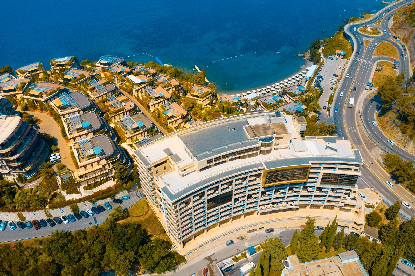 Aerial view of the curved Hotel Harmonia by Dukley on the Zavala peninsula above the Adriatic