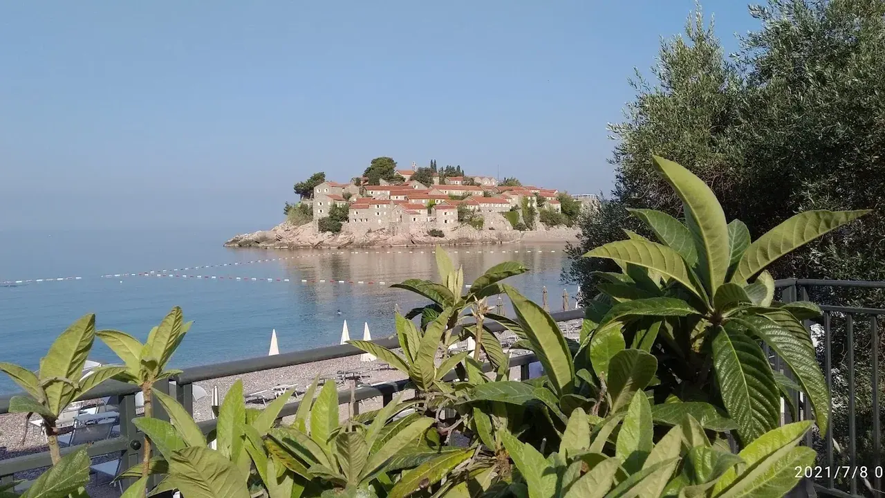 A rocky cove and clear turquoise water on the Budva Riviera coast near Sveti Stefan