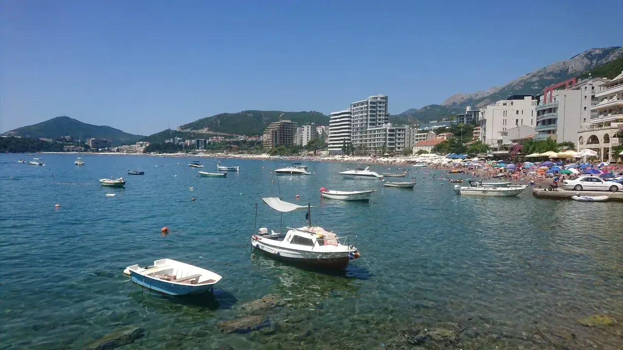 The village of Rafailovići on its point at the north end of Bečići Beach with fishing boats and waterfront buildings
