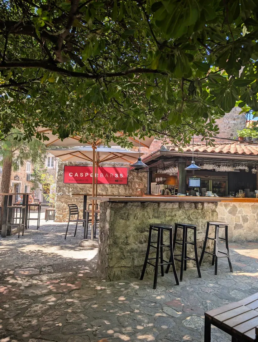 The stone bar counter and courtyard of Casper Bar in Budva Old Town, Montenegro