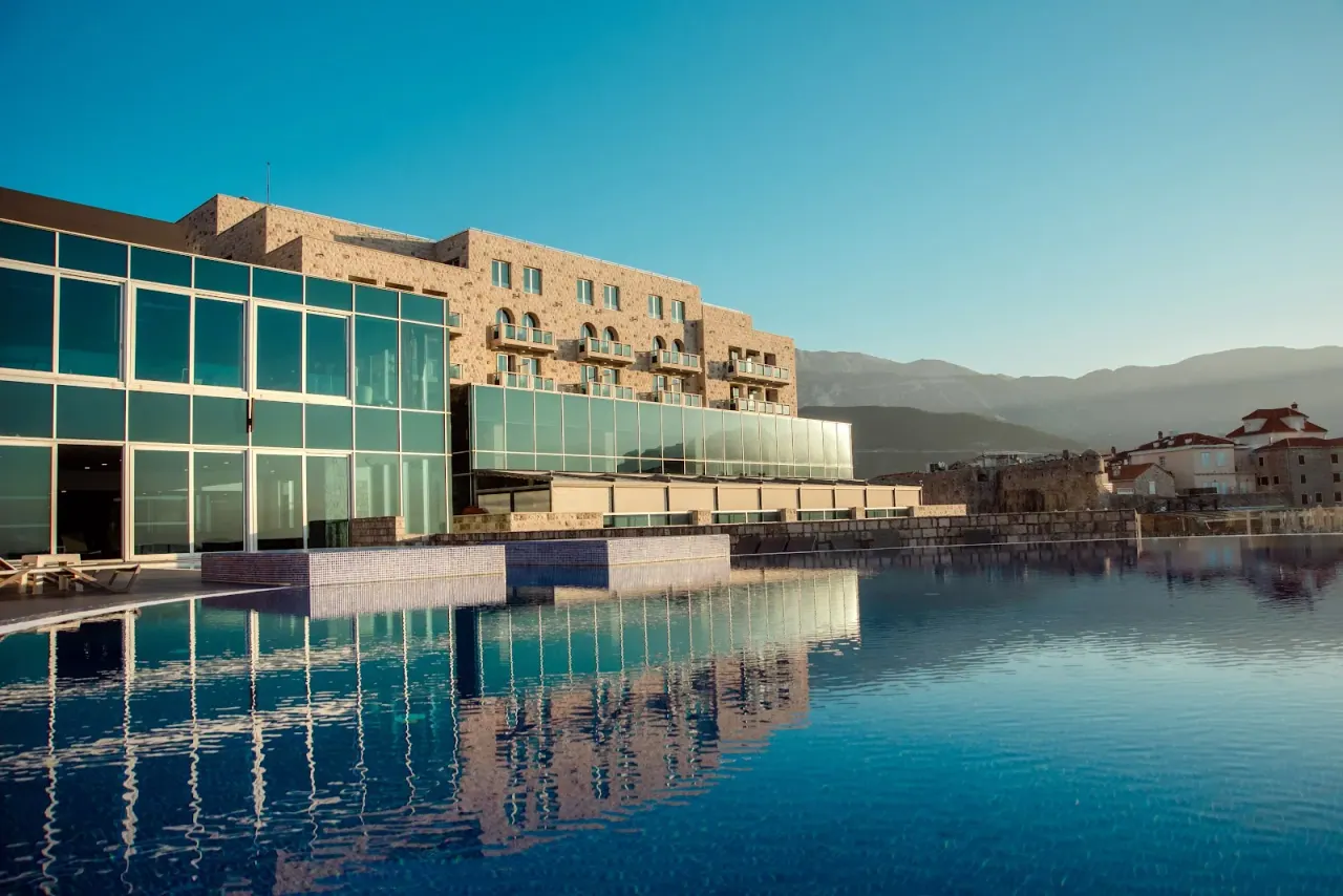 Infinity pool overlooking Budva's old town walls and the Adriatic at Avala Resort & Villas