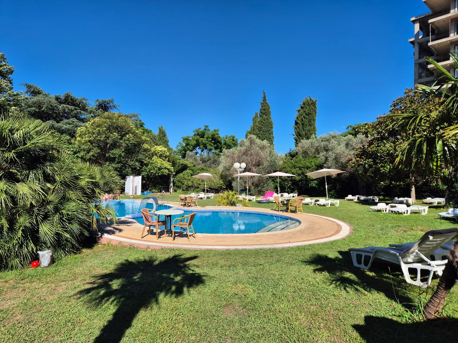 Outdoor pool and sun terrace with island views at Hotel Rivijera in Petrovac