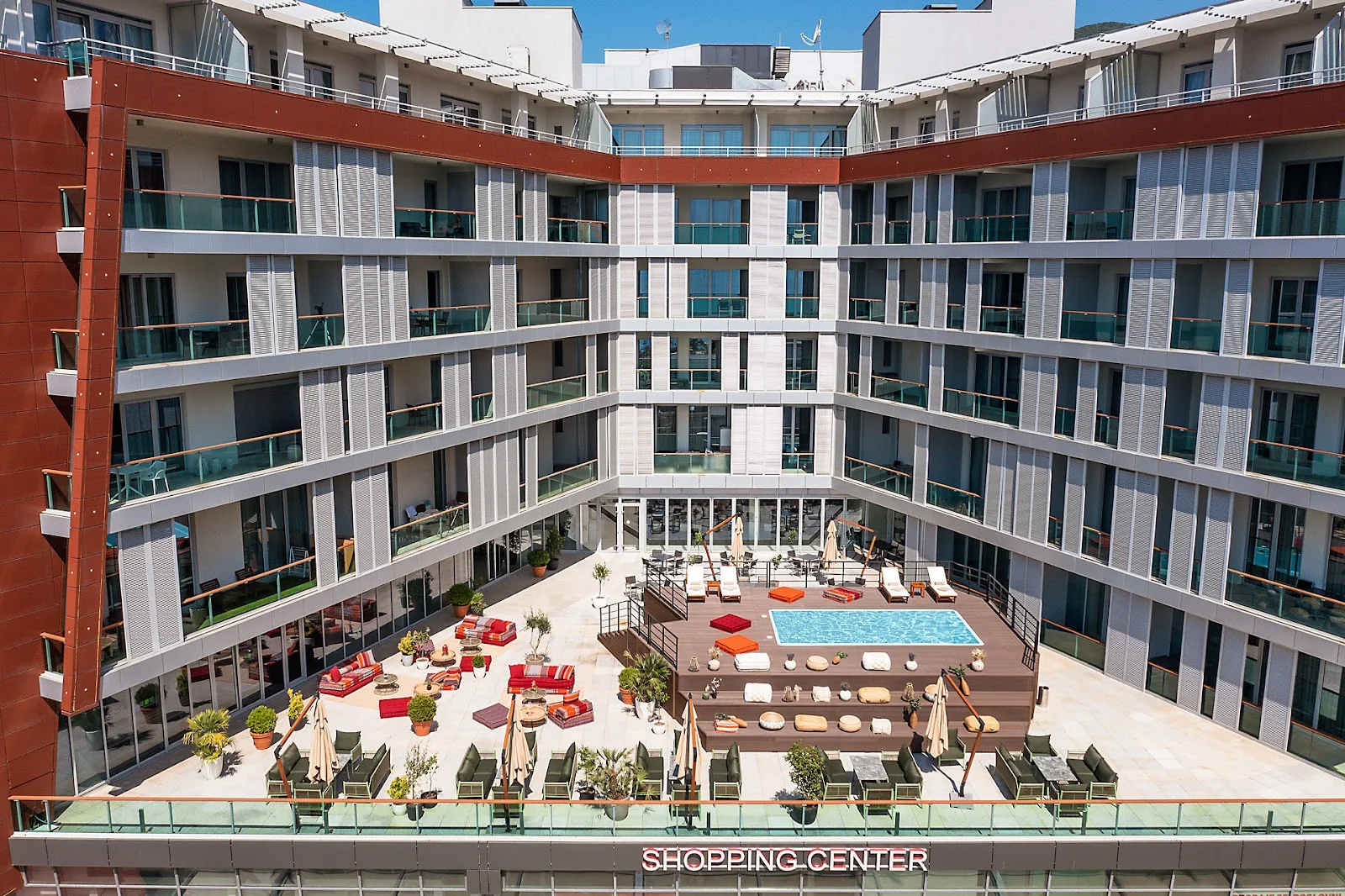 Aerial view of the courtyard pool and sun terrace at Hotel TQ Plaza in central Budva