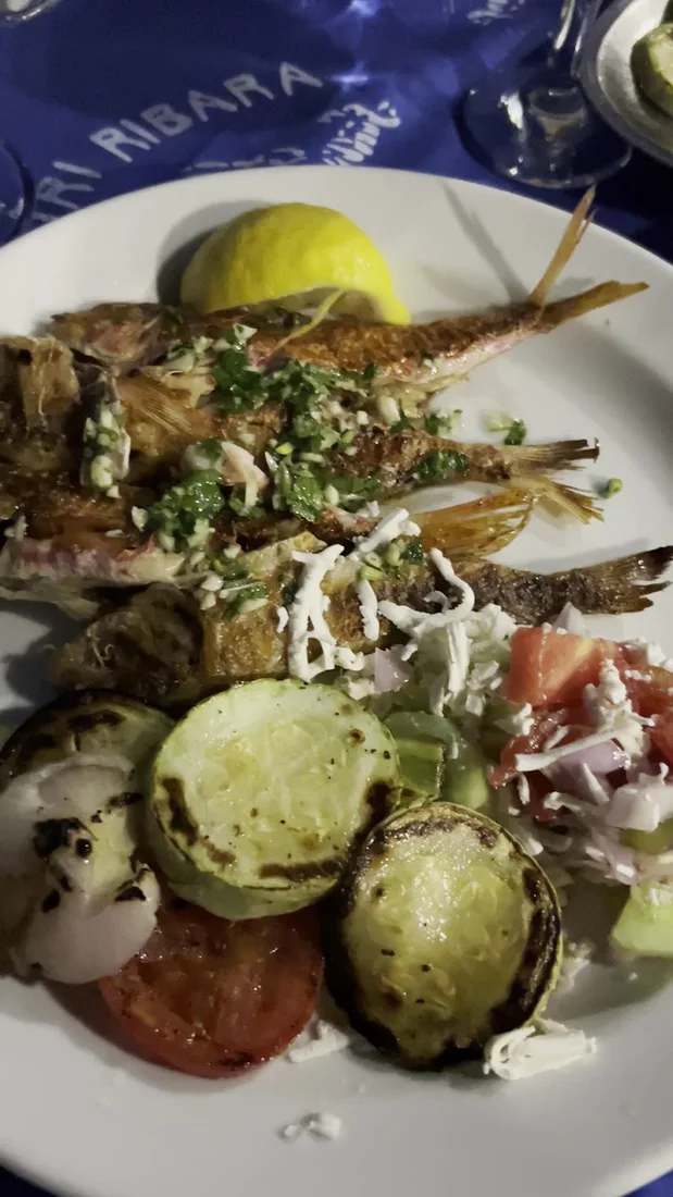 Plate of grilled fish with lemon and char-grilled vegetables at Tri Ribara in Rafailovići