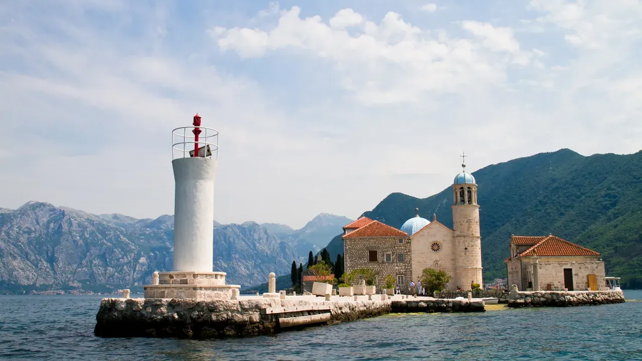 The islet church of Our Lady of the Rocks and its lighthouse in the Bay of Kotor near Perast