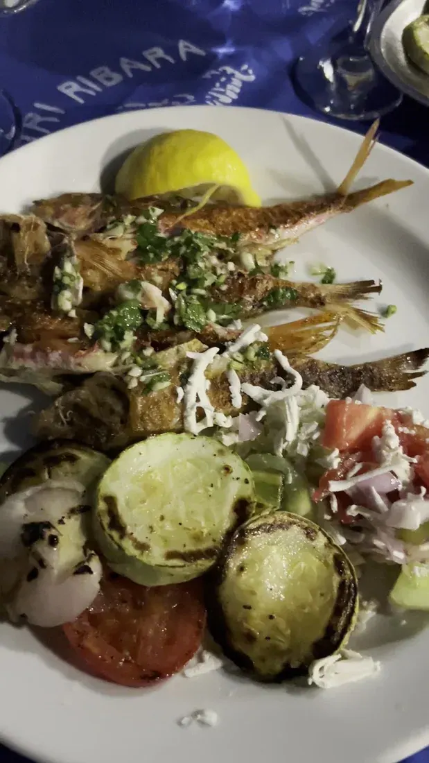 Plate of grilled fish with lemon and char-grilled vegetables at Tri Ribara in Rafailovići